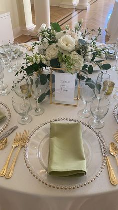 the table is set with silverware and place settings