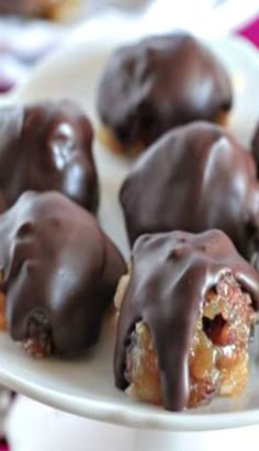 chocolate covered donuts on a white plate