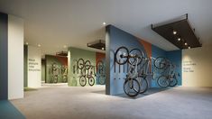 there are many bicycles hanging on the wall in this room with no one around them