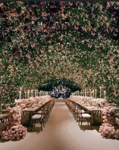 a long table set up with flowers and candles