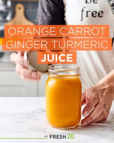 orange carrot ginger tumeric juice in a mason jar with the title overlay reads, orange carrot ginger tumeric juice