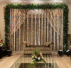 an elegant living room decorated with flowers and greenery