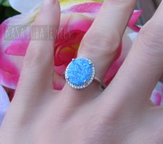 STUNNING Lab Opal CZ SOLID sterling stamped 925 silver Tarnish free sizes 4-11 4 5 6 7 8 9 10 11 Some sizes are sold out. But will be replenished shortly Top of ring height: 14.4mm / width: 12.8mm Shank width: 1.5mm lab created opal & clear cubic zirconia Center stone size: 11.8mm x 10.0mm Stone shape: Oval Total number of CZ stones: 28 Stone setting: Prong High Polished, solid 925 sterling silver. Rhodium plated to prevent tarnishing. TARNISH FREE Rhodium plated to avoid tarnishing Nothing but the best from my custom jewelry store. Email me if you have any questions. Silver Halo Design Rings As A Gift, Silver Rings With Halo Design As Gift, Silver Rings With Halo Design For Gift, White Gold Opal Ring With Halo Setting As Gift, Opal Rings With Halo Setting As A Gift, Opal Jewelry With Halo Setting For Gift, Silver Sterling Silver Opal Ring, White Gold Opal Rings As Gift, Sterling Silver Opal Promise Ring