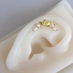 a pair of ear piercings sitting on top of a white piece of plastic material