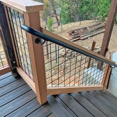 a wooden deck with metal railing on it