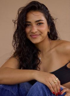 a woman sitting on the ground smiling