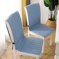 two blue and white chairs sitting next to each other on top of a hard wood floor