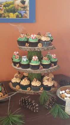 cupcakes are stacked on top of each other in the shape of a christmas tree