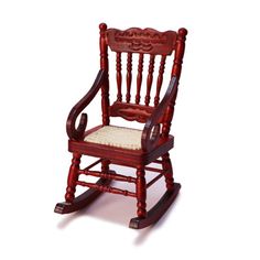 a red wooden rocking chair with a white cushion