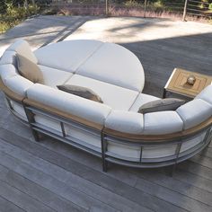 a white couch sitting on top of a wooden deck