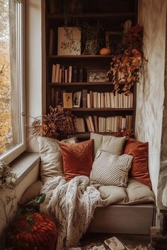 a couch sitting in front of a window filled with books