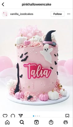 a pink cake with white and black decorations on it's side, topped with a name that reads talia