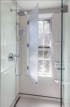 a bathroom with a glass shower door and window