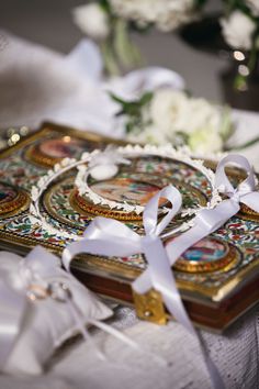 a white ribbon is tied around a decorative box