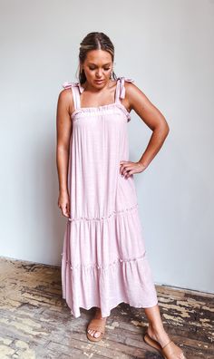 Up your Summer style game with this fab maxi dress! Irresistibly chic with its tiered design, ruffle neckline, and tie-shoulder detail, this babydoll style dress will help you stand out on even the hottest days. And what better color to show off in than lilac? Get ready to rock the beach in style! Feminine Maxi Dress With Tie Straps, Pink Tiered Maxi Dress For Day Out, Flowy Maxi Dress With Tie Straps For Brunch, Casual Pink Tiered Dress With Ruffled Straps, Pink Maxi Dress With Ruffled Straps For Vacation, Ruffled Strap Maxi Dress With Tie Straps For Brunch, Ruffled Straps Maxi Dress With Tie Straps For Brunch, Flowy Maxi Dress With Tie Straps For Day Out, Chic Pink Maxi Dress With Tie Straps