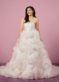 a woman in a white wedding dress posing for the camera