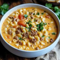 a white bowl filled with pasta and meat soup