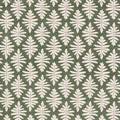 a green and white rug with leaves on it