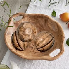 a wooden bowl with two glass bowls on it