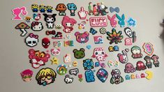 an assortment of pixel stickers are displayed on a refrigerator door in this image, there is also a fridge magnet that has been decorated with the characters