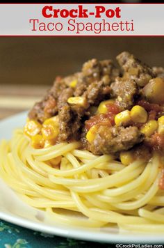 a close up of a plate of spaghetti with meat and corn on top, text reads crock - pot taco spaghetti