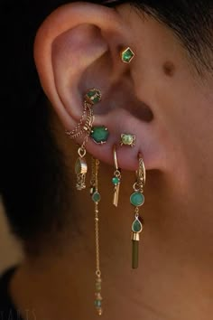 a close up of a person's ear with some piercings on top of it