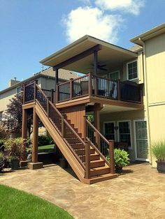 a brown house with stairs leading up to it