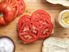 tomatoes, bread and mayonnaise on a cutting board