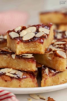 a white plate topped with almond bars on top of a table