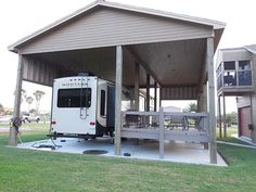 an rv is parked under a covered patio