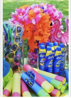 there are many items on the table for sale at this party, including sunglasses and flowers