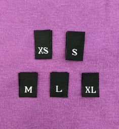 four pieces of cloth with the letters xs, s, and l on them