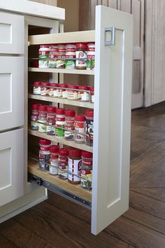 an open cabinet in a kitchen filled with food