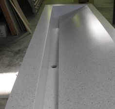 a long counter top with two holes in the middle and one hole at the end