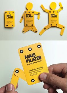 a person holding up some yellow business cards