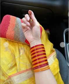 a woman in a yellow sari is holding her hand up