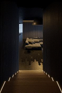 a room with several beds in it and some lights on the wall next to them