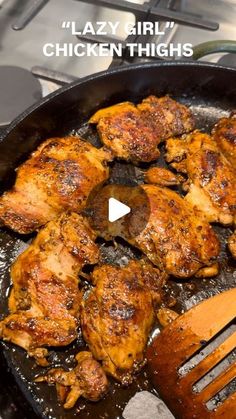 chicken thighs cooking in a skillet on the stove