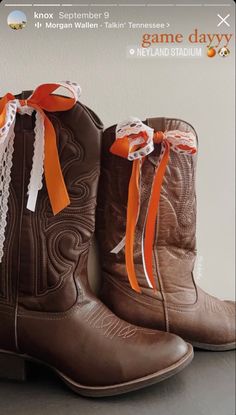 Ribbon On Boots, Ribbon On Cowboy Boot, Ut Austin Game Day Outfit, Cowgirl Boots Outfit Gameday, Game Day Boots Ribbon, Red Cowgirl Boots Aesthetic, Brown Cowboy Boots Aesthetic, Boots With Ribbon, Brown Cowgirl Boots Aesthetic