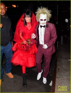 a man and woman dressed up in costumes