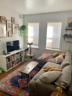 a living room filled with furniture and a flat screen tv on top of a wooden table