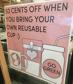 a sign that says go green on the side of a glass case in a store