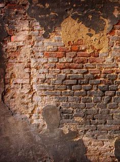 an old brick wall with peeling paint on it