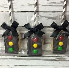 three candy bags with black bows and candies in them