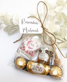 a bag filled with assorted chocolates next to a sign that reads raman mubara