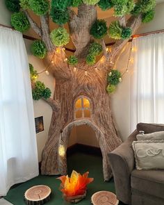 a living room decorated with fake trees and lights on the ceiling, along with other decorations