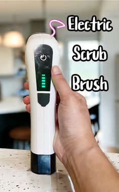 the electric scrub brush is being held up by someone's hand with text overlay