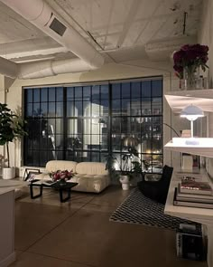 a living room filled with furniture and lots of windows