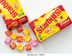 two boxes of gummy's orange and strawberry candy on a white background - stock image