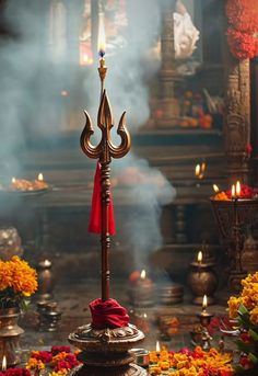 an ornate candle holder with candles and flowers in front of the altar at a hindu temple